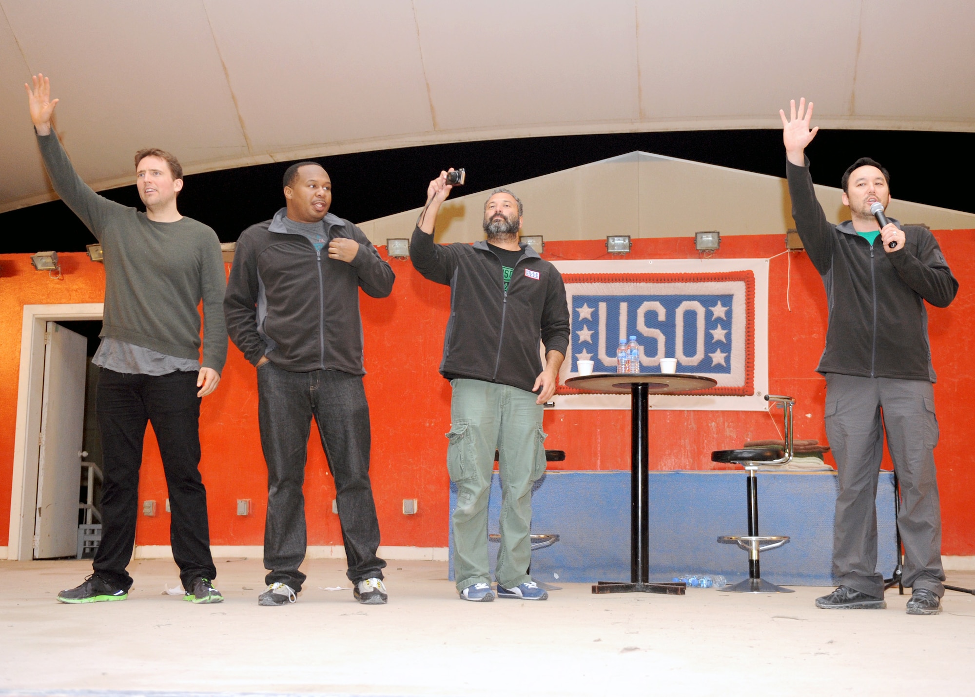 SOUTHWEST ASIA – From left, Owen Benjamin, Roy Woods Jr., Ahmed Ahmed and Steve Byrne thank U.S. Service members for their continued support and sacrifices after a comedy show Jan. 6. The comedians were part of the Sullivan & Son Comedy Tour put on by the USO. (U.S. Air Force photo/Senior Airman Joel Mease)