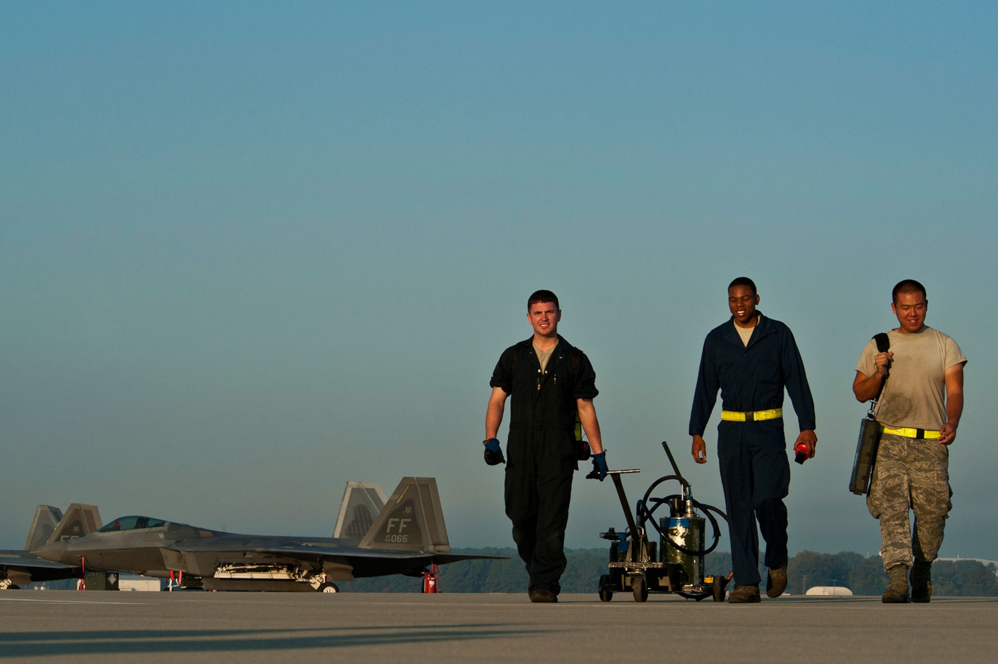 (From left) Airman 1st Class Travis Miron, Senior Airman Justin Stith and Airman 1st Class San You, all F-22 Raptor crew chiefs, walk off the Joint Base Langley-Eustis flightline after eight successful F-22 takeoffs. (U.S. Air Force photo/Tech. Sgt. Bennie J. Davis III)