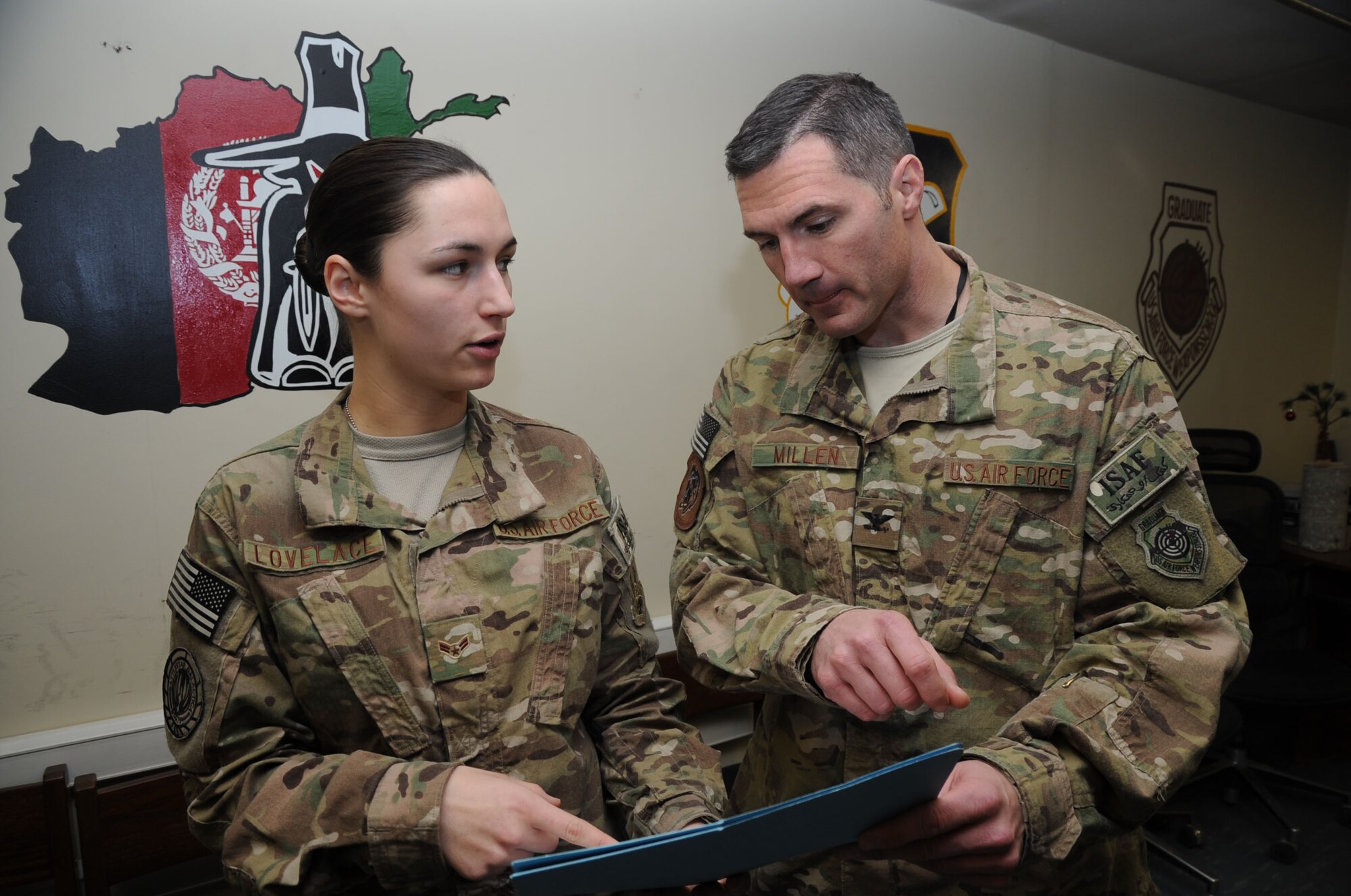 BAGRAM AIRFIELD, Afghanistan - Airman 1st Class Ashley Lovelace briefs Col. Michael Millen, 455th Expeditionary Operations Group commander, in the 455th Expeditionary Operations Support Squadron conference room here, Jan. 5, 2013. Lovelace is an intelligence specialist for the 455th EOSS who develops products for leadership on potential airstrikes. (U.S. Air Force photo/Staff Sgt. David Dobrydney)