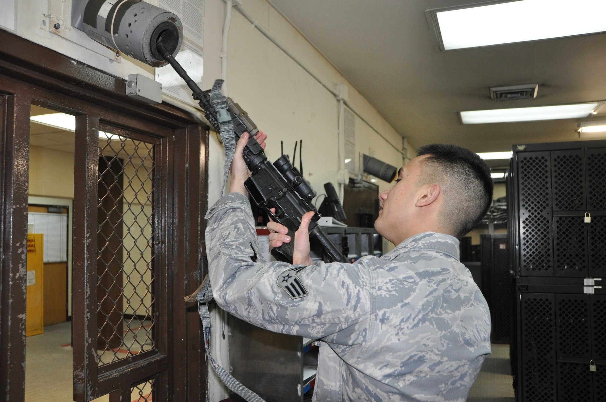 Senior Airman Andrew Smalley, 51st Security Forces armory assistant NCO in charge, inspects the barrel of an M-4 carbine for cleanliness Jan. 4, 2013. After each shift, weapons must be cleared by the security forces Airmen, and then turned into the armory for security until the individual needs it again for duty. (U.S. Air Force photo/Senior Airman Kristina Overton)