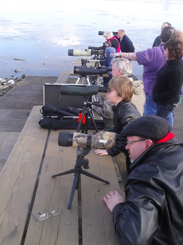 Members of the public use spotting scopes set up for the 16th Annual Eagle Days on Jan. 5, 2013, at Smithville Lake in Missouri. Approximately 2,150 people attended the event, many of which had never been to the lake. About 15 eagles performed for the crowds around the lake while Operation Wildlife hosted seven live eagle shows indoors over the weekend. Photo by Derek R. Dorsey.