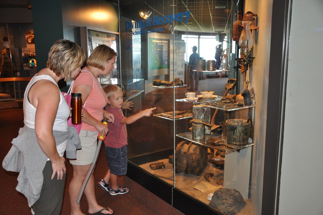 Visitors to the Lake Superior Maritime Visitor Center view artifacts in a diving and recovery display in Duluth, Minn.