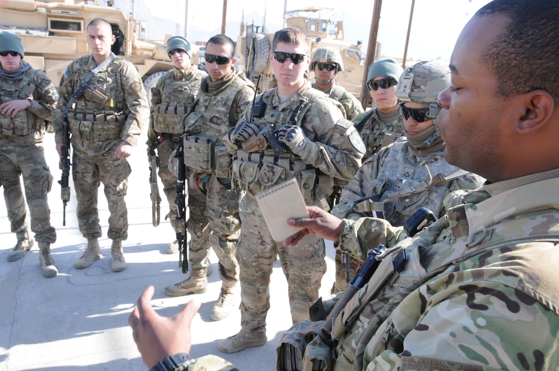 U.S. Army Staff Sgt. Roderick Cooper, front right, provides a team ...