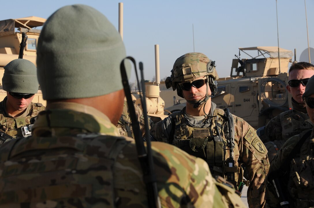 U.S. Army Capt. Jeremiah Gebhart, center, listens as Staff Sgt ...