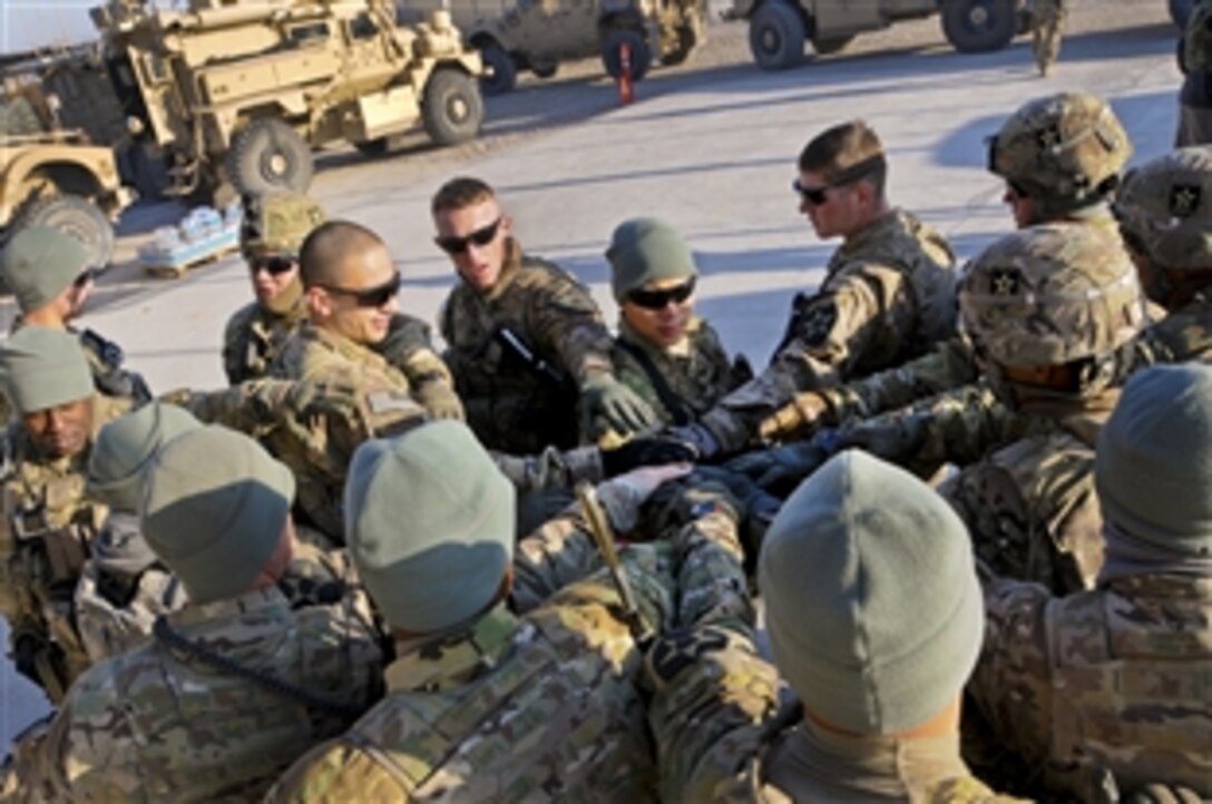U.S. soldiers and sailors assigned to Provincial Reconstruction Team Farah come together before leaving for a mission in Farah City, Afghanistan, Jan. 6, 2013. The meeting, with the provincial director of commerce and industry, enabled team members to discuss ongoing initiatives in the province to spur economic growth and development.
