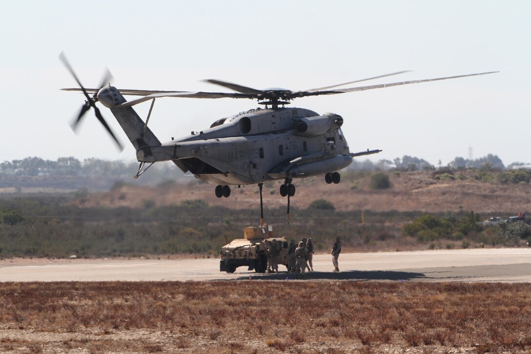 A CH-53E Super Stallion lifts an armored vehicle during the Marine Air Ground Task Force demonstration, a portion of the 2012 Marine Corps Air Station Miramar Air Show, Oct. 13. Aircraft like the Super Stallion provide troops on the ground necessary support when performing specific missions overseas.