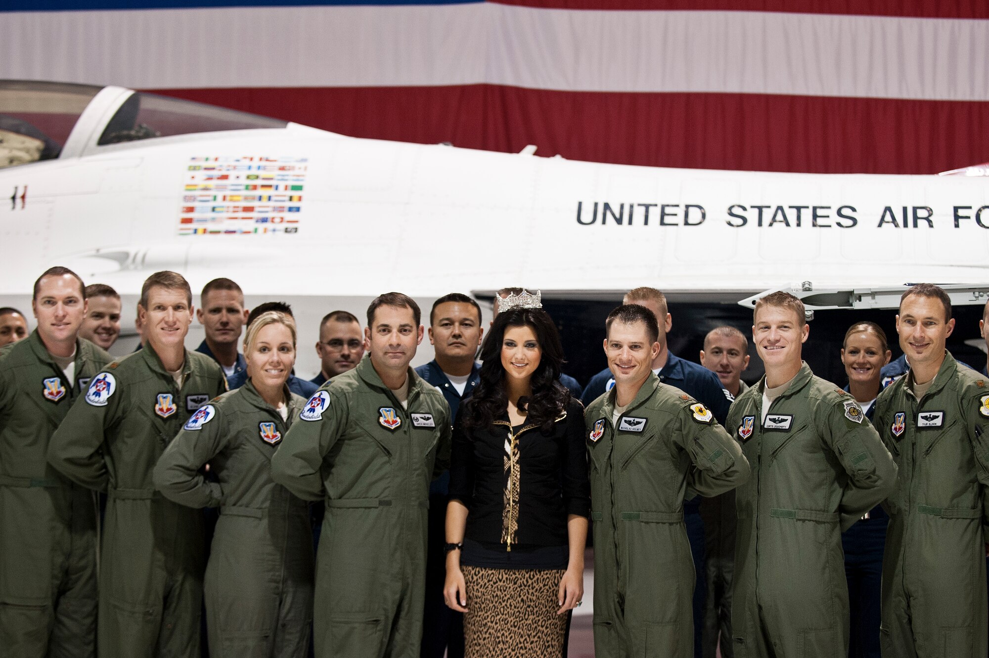Laura Kaeppeler, Miss America 2012, poses with members of the United States Air Demonstration Squadron “Thunderbirds” during a visit to the Thunderbirds hangar, Jan. 8, 2013, at Nellis Air Force Base, Nev. Kaeppeler has worked closely with United Service Organizations, which is a nonprofit organization that provides programs, services and live entertainment to United States military and their families. (U.S. Air Force Photo by Airman 1st Class Jason Couillard)