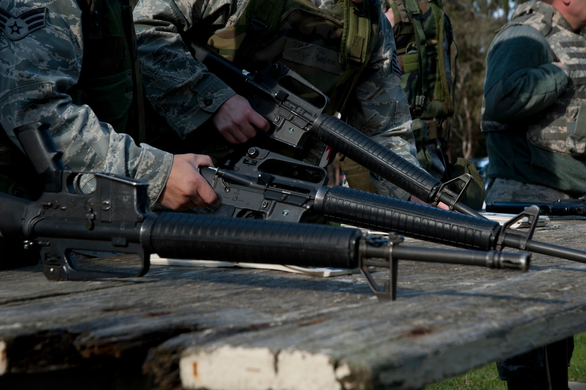VANDENBERG AIR FORCE BASE, Calif. --  Vandenberg Airmen consult their Airmen’s Manuals during a weapons check station at Cocheo Park to practice for a Northstar exercise here Monday, Jan. 7, 2013. The Northstar exercise is designed to test the deployment capabilities and combat survival skills of Vandenberg Airmen. (U.S. Air Force photo/Senior Airman Lael Huss)

