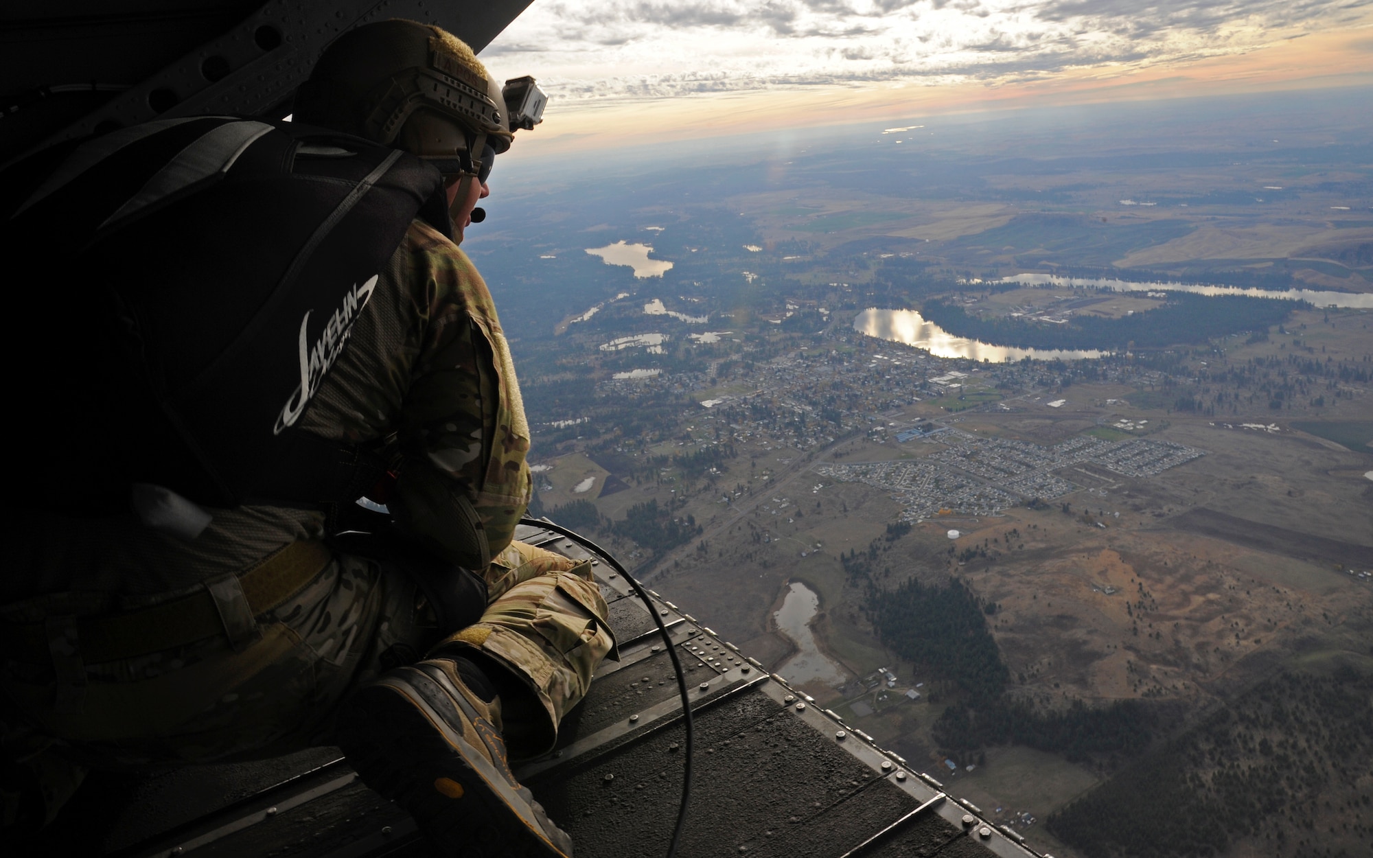 Tech. Sgt. Jesse Stoda looks out the back of a CH-47 Chinook over Fairchild Air Force Base, Wash., Nov. 6, 2012. He is waiting for the helicopter to gain altitude to perform a free-fall jump. Stoda is a survival evasion resistance and escape specialist with the 22nd Training Squadron. (U.S. Air Force photo by Airman 1st Class Ryan Zeski) 