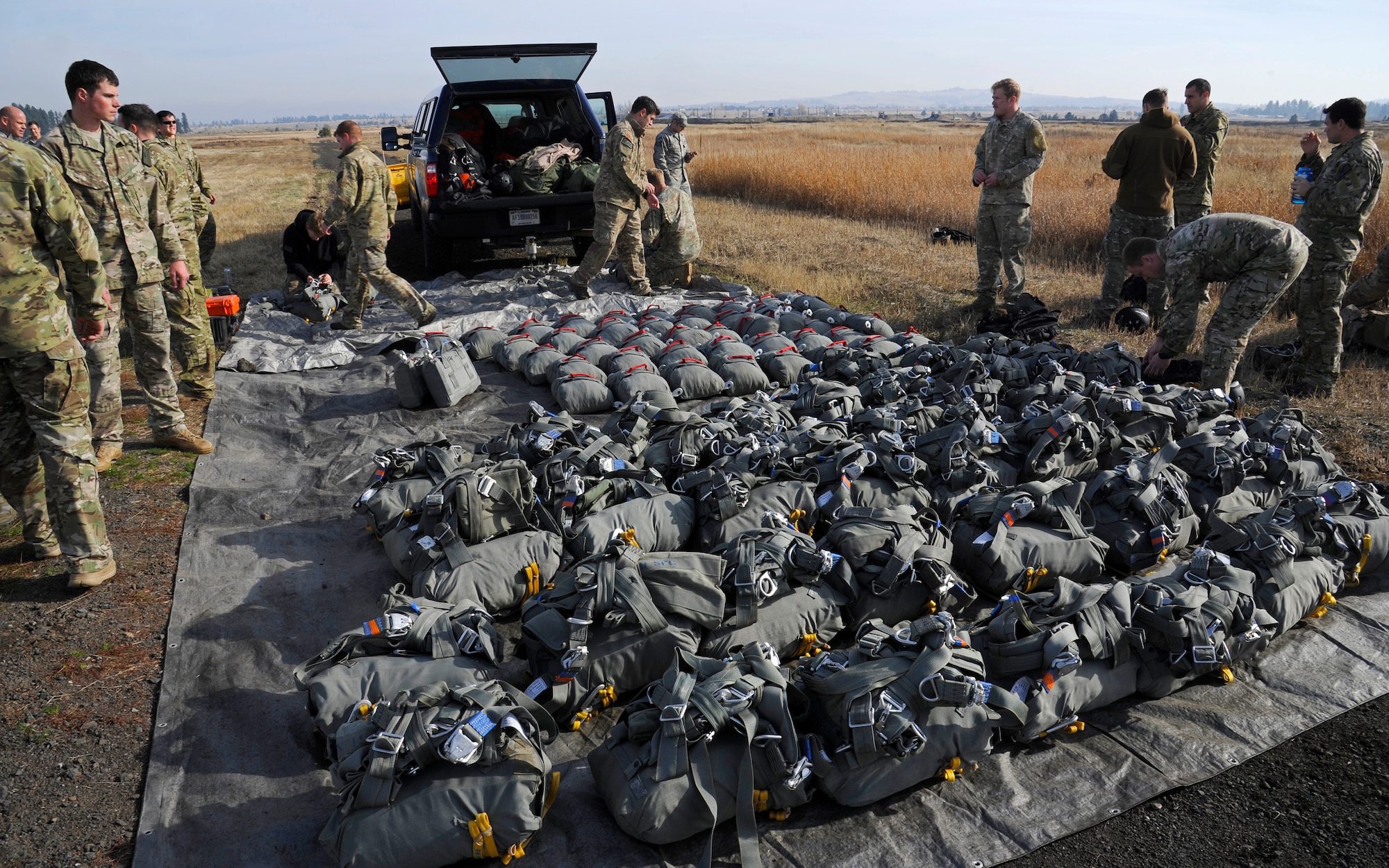 Survival evasion resistance and escape specialists unload parachute equipment before they perform static-line jumps at Fairchild Air Force Base, Wash., Nov. 6, 2012. (U.S. Air Force photo by Airman 1st Class Ryan Zeski)