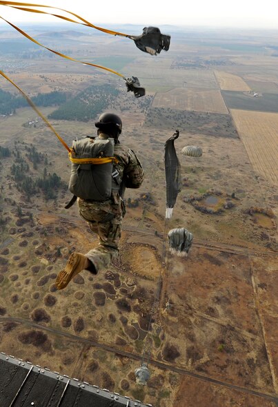 Survival, evasion, resistance and escape specialists execute static-line jumps from a CH-47 Chinook helicopter over Fairchild Air Force Base, Wash., Nov. 6, 2012. Static line jumps are performed at altitudes as low as 400 feet. (U.S. Air Force photo/Airman 1st Class Ryan Zeski)