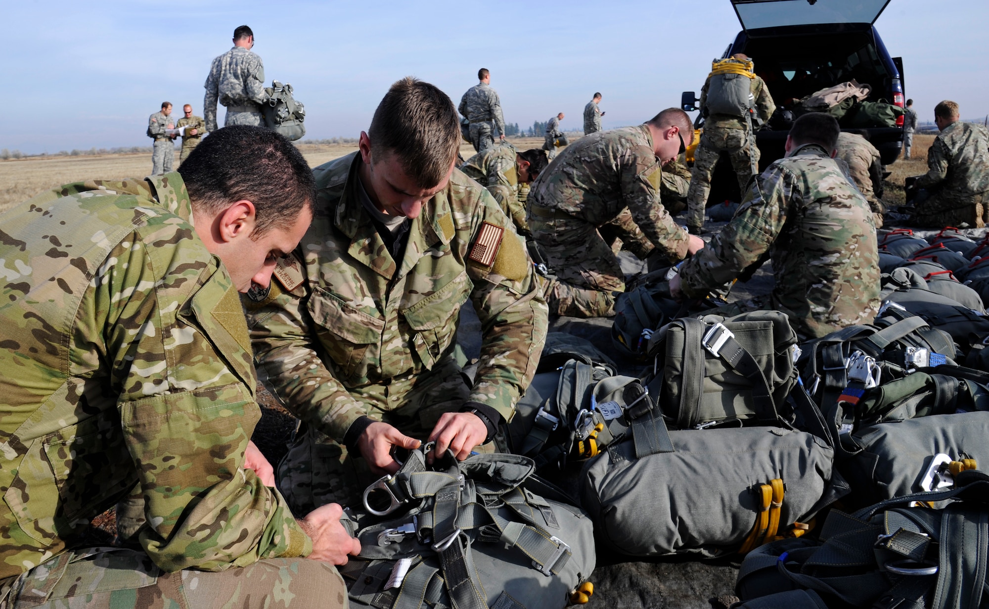 Survival, evasion, resistance and escape specialists prepare parachutes for static-line jumps at Fairchild Air Force Base, Wash., Nov . 6, 2012. A static line jump is normally conducted at 1,250 feet above the ground. (U.S. Air Force photo by Airman 1st Class Ryan Zeski)