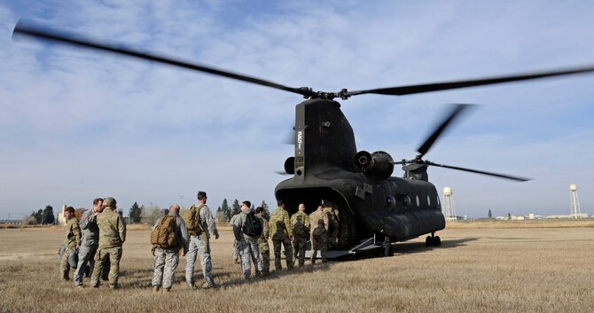 Survival, evasion, resistance and escape specialists load into a CH-47 Chinook helicopter to practice static-line jumps at Fairchild Air Force Base, Wash., Nov. 6, 2012. These jumps are performed by instructors and students to ensure students are receiving the proper training. (U.S. Air Force photo/Airman 1st Class Ryan Zeski)