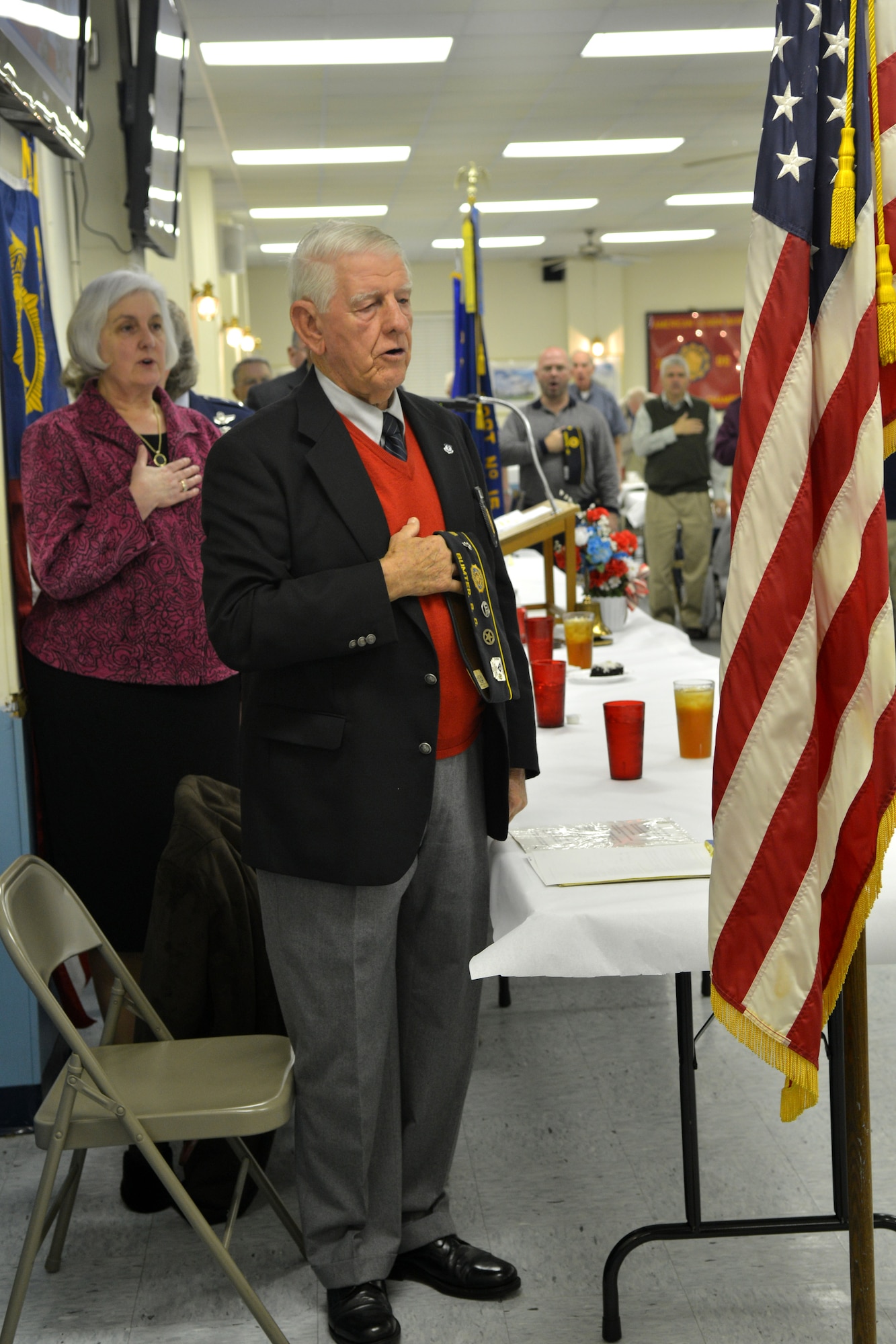 Tony Meyers, American Legion Post 15 program chairman, shows respect for the American flag after the colors are presented, Sumter, S.C., Jan. 7, 2013. There are currently 15,000 American Legion Posts worldwide.(U.S. Air Force photo by Airman 1st Class Ashley L. Gardner/ Released)
