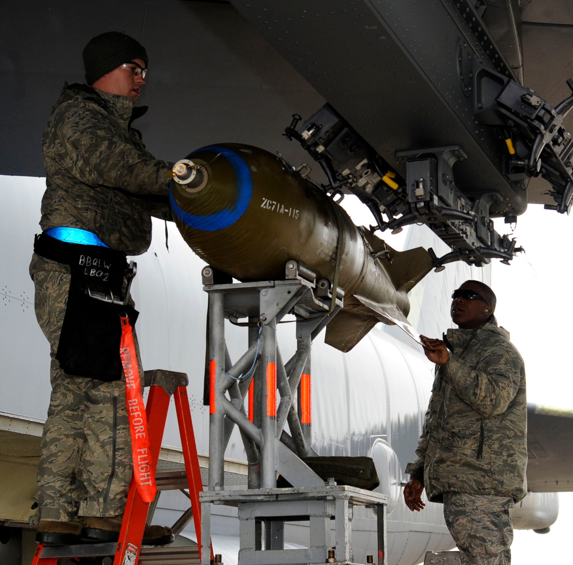 Staff Sgt. Adolfo Trujillo and Senior Airman Akeem Bobo inspect an inert M117 general purpose bomb on a B-52H Stratofortress on Barksdale Air Force Base, La., Jan. 8. The two Airmen loaded the bomb during a monthly proficiency requirement load, which is refresher training to keep Airmen qualified and familiarized with weapons loading to be prepared for any situation. (U.S. Air Force photo/Airman 1st Class Andrew Moua)