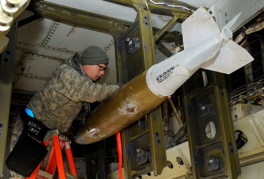 Staff Sgt. Adolfo Trujillo, 2nd Maintenance Group weapons standardization section, secures an inert Mk 82 general purpose bomb during a monthly proficiency requirement load on Barksdale Air Force Base, La., Jan. 8. MPRLs ensure Airmen stay qualified to load munitions and are properly versed in weapons loading procedures. (U.S. Air Force photo/Airman 1st Class Andrew Moua)