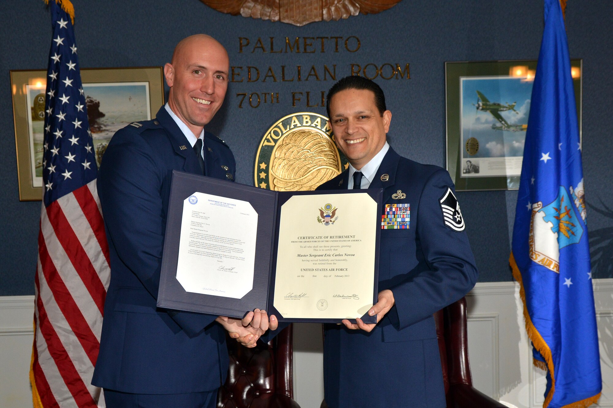 U.S. Air Force Capt. Robert Montgomery, 20th Component Maintenance Squadron maintenance operations officer, presents the certificate of retirement to Master Sgt. Eric Novoa, 20th CMS programs flights chief, Shaw Air Force Base, S.C., Jan. 4, 2013. Retirement ceremonies are held for retirees to recognize their service and all that they have done to help the mission. (U.S. Air Force photo by Airman 1st Class Ashley L. Gardner/Released)

