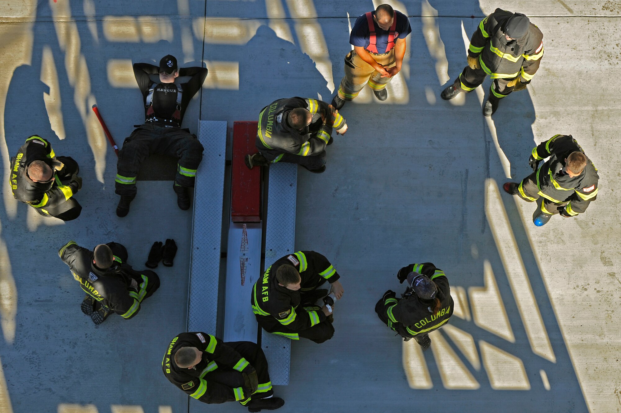 Two Team Shaw 20th Civil Engineer Squadron firefighters and Columbia firefighters take a break after a few hours of training. Oct. 29, 2012. Team Shaw firefighters teamed with Columbia firefighters to train for the Scott Firefighter Combat Challenge worldwide competition in Myrtle Beach, S.C. The competition took place Nov. 12 and 17, 2012 and Team Shaw’s firefighters took 6th place amongst the top 20 teams in the team portion of the competition. (U.S. Air Force photo by Staff Sgt. Kenny Holston/Released) 