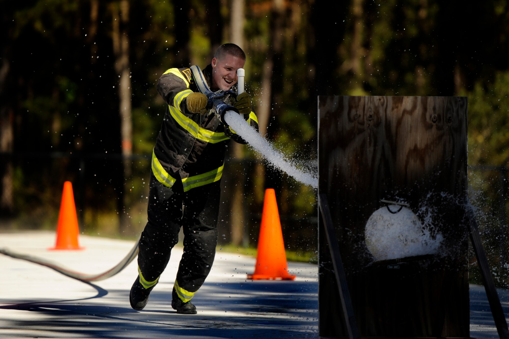 A Team Shaw 20th Civil Engineer Squadron firefighter hits his target with water from a fire hose during a training session in preparation for the Scott Firefighter Combat Challenge worldwide competition in Myrtle Beach, S.C. Oct. 29, 2012. The competition took place Nov. 12 and 17, 2012 and Team Shaw’s firefighters took 6th place amongst the top 20 teams in the team portion of the competition. (U.S. Air Force photo by Staff Sgt. Kenny Holston/Released) 