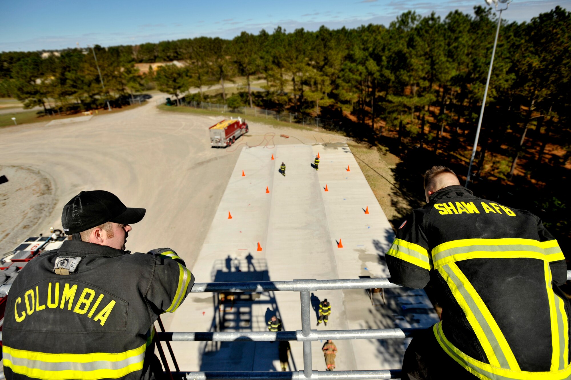 A Team Shaw 20th Civil Engineer Squadron firefighter looks from the top of Shaw’s firefighter training tower with a member of the Columbia Fire Department during an intense training session in preparation for the Scott Firefighter Combat Challenge worldwide competition at Myrtle Beach, S.C. Oct. 29, 2012. The competition took place Nov. 12 and 17, 2012 where Team Shaw’s firefighters took  6th place amongst the top 20 teams in the team portion of the competition. (U.S. Air Force photo by Staff Sgt. Kenny Holston/Released) 