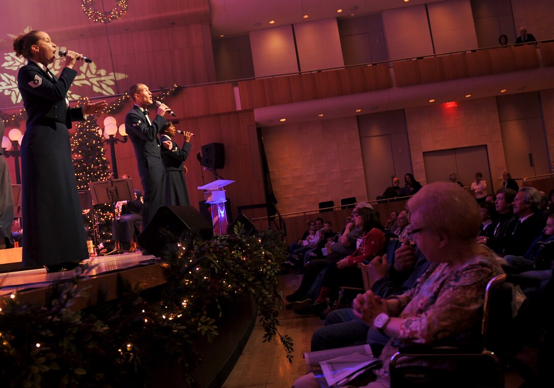 Technical Sergeant Rebecca Packard, Airman First Class Lee Heerspink, and Airman First Class Paula Kynard sing for an appreciative audience at "A Hometown Holiday"