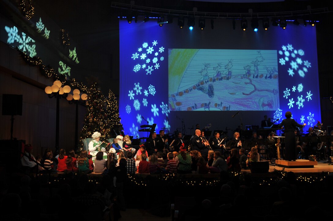 Mrs. Clause narrates "How the Grinch Stole Christmas!" for children while the Concert Band provides the score accompanied by drawings from local students.