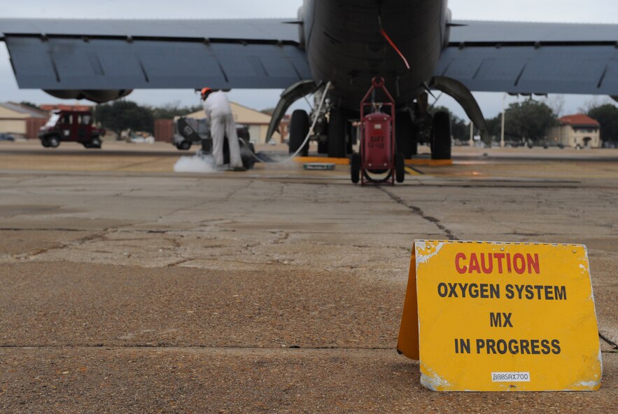 A caution sign is displayed near a B-52H Stratofortress during liquid oxygen servicing by Senior Airman Princeton Drake, 20th Aircraft Maintenance Unit crew chief, on Barksdale Air Force Base, La., Jan. 8. During this portion of a preflight inspection, personnel are required to stay more than 25 feet away for safety reasons. (U.S. Air Force photo/Airman 1st Class Benjamin Gonsier)