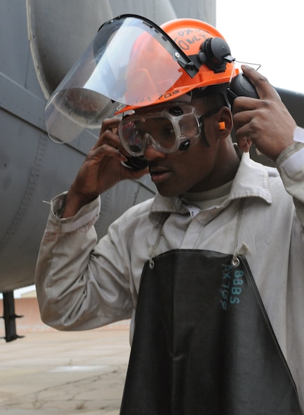 Senior Airman Princeton Drake, 20th Aircraft Maintenance Unit crew chief, dons personal protection equipment before servicing liquid oxygen to a B-52H Stratofortress on Barksdale Air Force Base, La., Jan. 8. The B-52 is required to have more than 30 liters of liquid oxygen onboard and is used as breathing oxygen for the aircrew during flight. (U.S. Air Force photo/Airman 1st Class Benjamin Gonsier)
