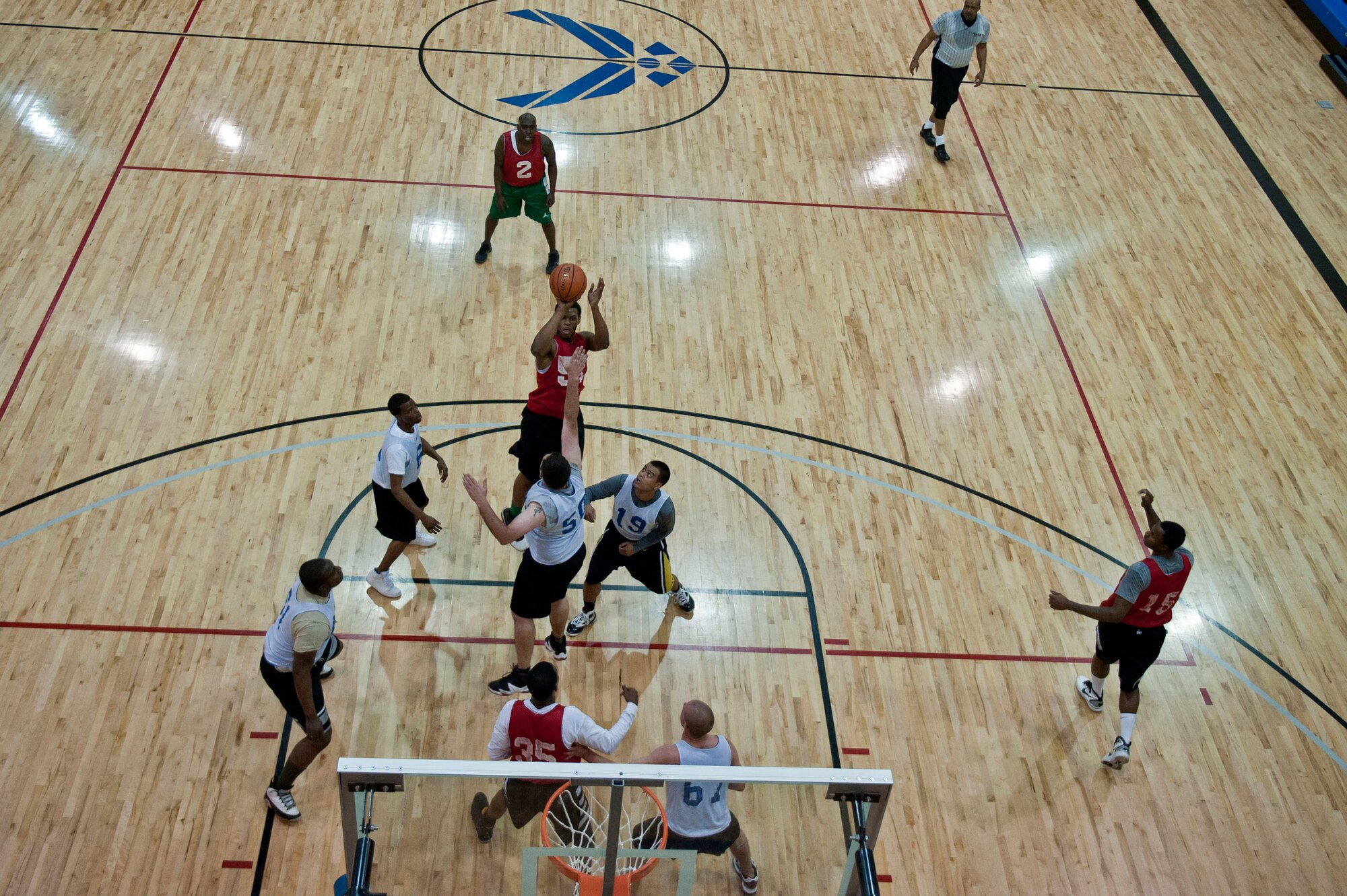 An Airman from the 563 Operational Support Squadron, shoots a jump shot in a game against the 757th Aircraft Maintenance Squadron, Jan. 7, 2013, in the Warrior Fitness Center at Nellis Air Force Base, Nev. This was the opening game of the 2013 Nellis, Creech intramural basketball season.  (U.S. Air Force Photo by Senior Airman Daniel Hughes)