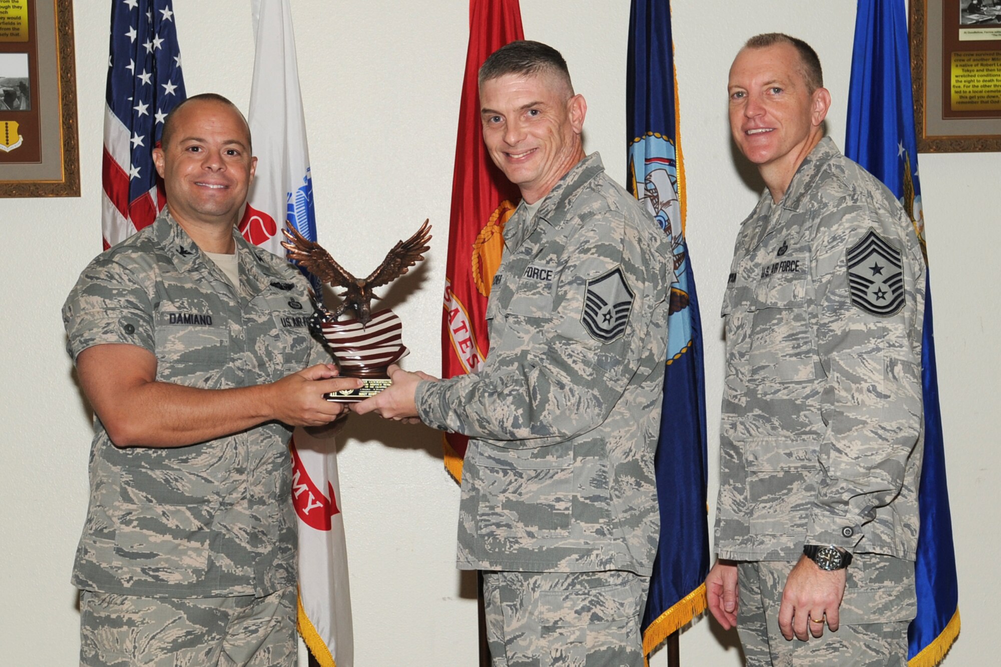 GOODFELLOW AIR FORCE BASE, Texas- Col. Mark Damiano, 17th Training Wing Commander, and Chief Master Sgt. Scott Lumpkin, 17th TRW Command Chief, present the Team Goodfellow Senior Service Member of the Quarter award to Master Sgt. Kevin Belcher, 17th Medical Support Squadron, during the wing quarterly awards ceremony  here, Jan. 8. (U.S. Air Force photo/ Staff Sgt. Laura R. McFarlane)