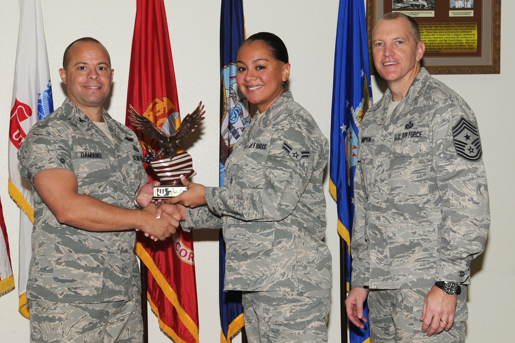 GOODFELLOW AIR FORCE BASE, Texas- Col. Mark Damiano, 17th Training Wing Commander and Chief Master Sgt. Scott Lumpkin, 17th TRW Command Chief, present the Team Goodfellow Junior Enlisted Servicemember of the Quarter award to Airman 1st Class Katherine Vela, 17th Medical Support Squadron, during the wing quarterly awards ceremony here, Jan. 8. (U.S. Air Force photo/ Staff Sgt. Laura R. McFarlane)