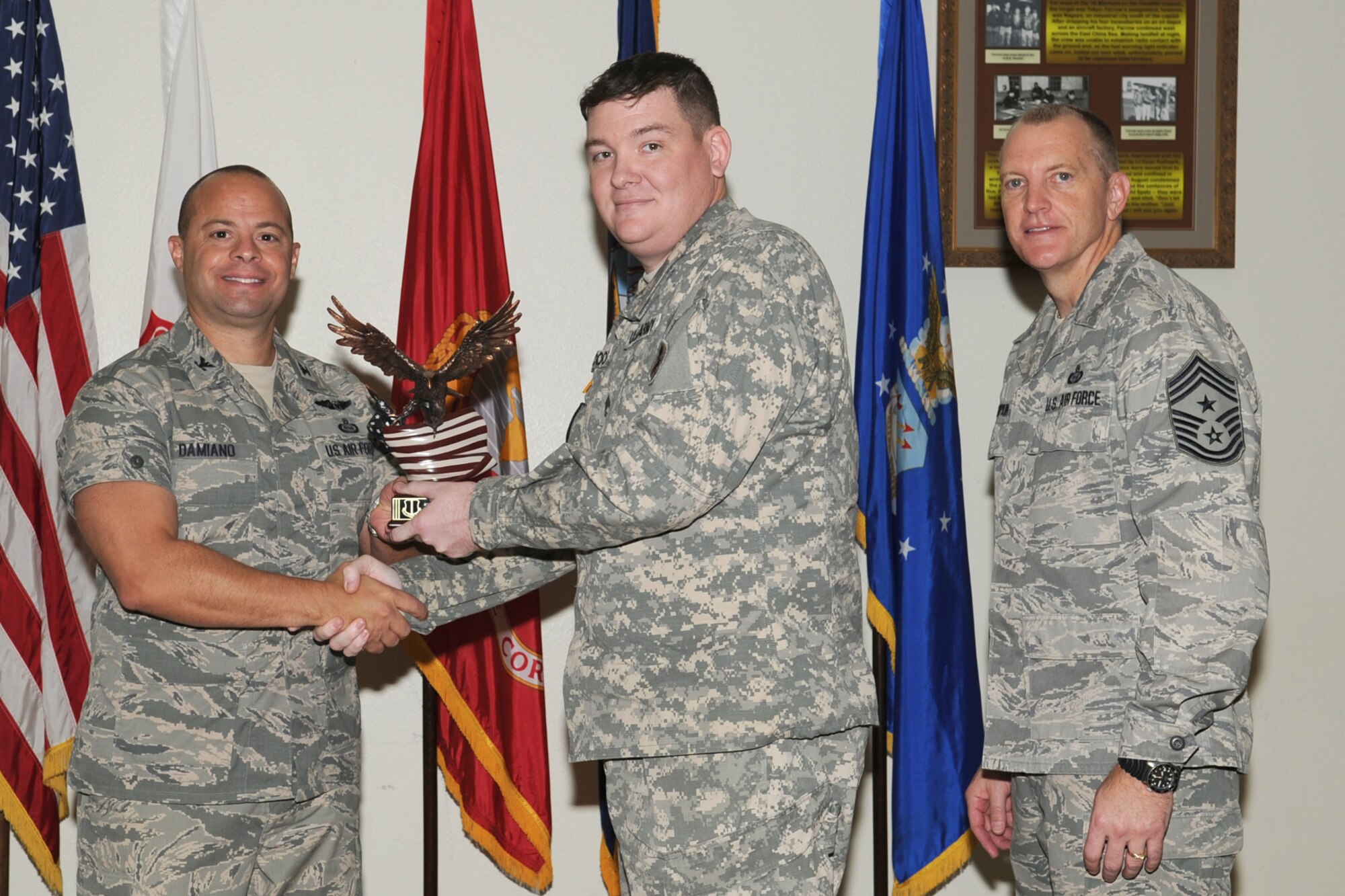 GOODFELLOW AIR FORCE BASE, Texas- Col. Mark Damiano, 17th Training Wing Commander and Chief Master Sgt. Scott Lumpkin, 17th TRW Command Chief, present the Team Goodfellow Joint Color Guard of the Quarter award to Army Sgt. 1st Class Daniel Cooke, 344th Military Intelligence Battalion, during the wing quarterly awards ceremony here, Jan. 8. (U.S. Air Force photo/ Staff Sgt. Laura R. McFarlane)