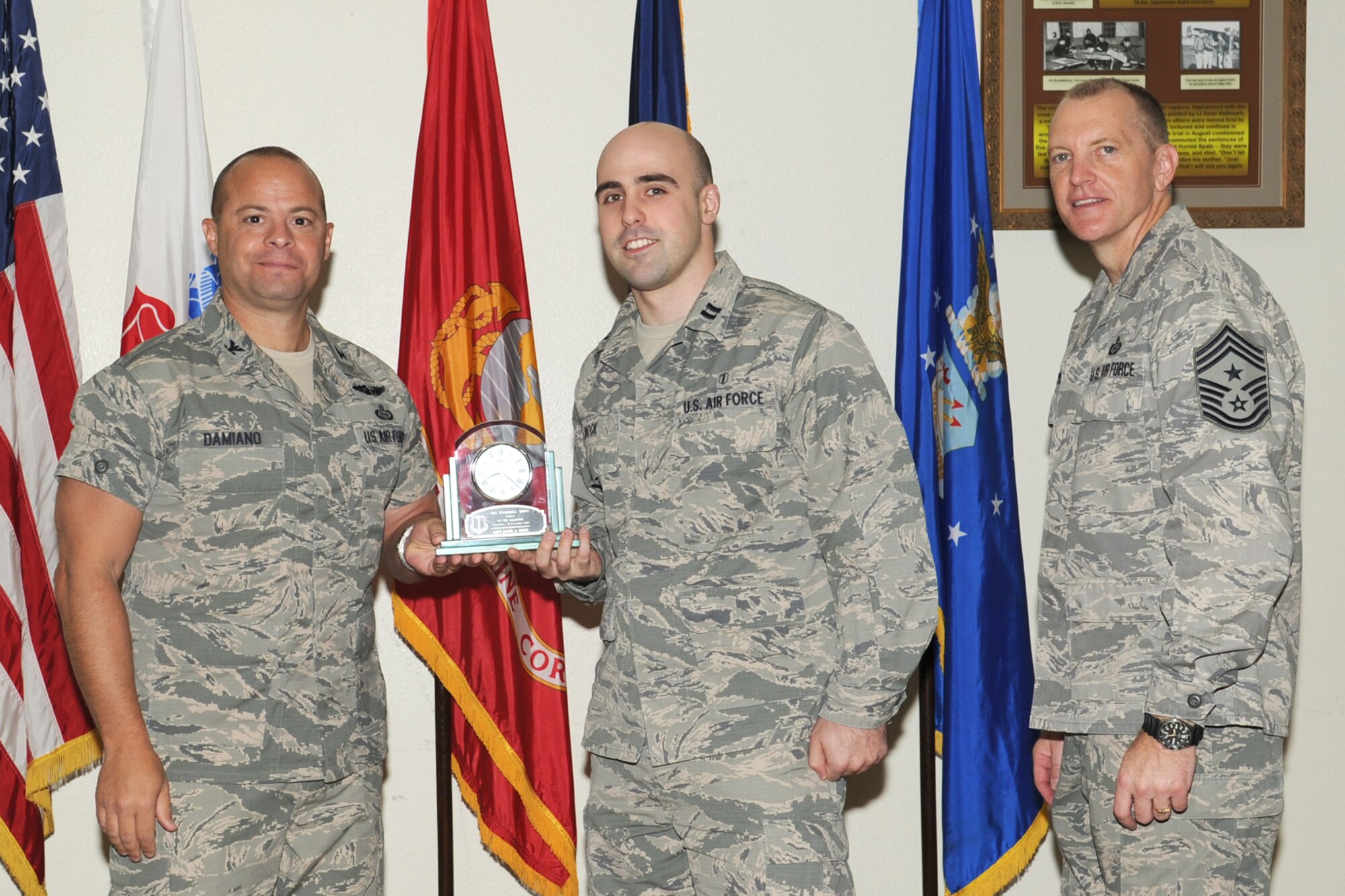 GOODFELLOW AIR FORCE BASE, Texas- Col. Mark Damiano, 17th Training Wing  Commander and Chief Master Sgt. Scott Lumpkin, 17th TRW Command Chief, present the 17th Training Wing Company Grade Officer of the Quarter to Capt. Jacob Mock, 17th Medical Support Squadron, during the wing quarterly awards ceremony here, Jan. 8. (U.S. Air Force photo/ Staff Sgt. Laura R. McFarlane)