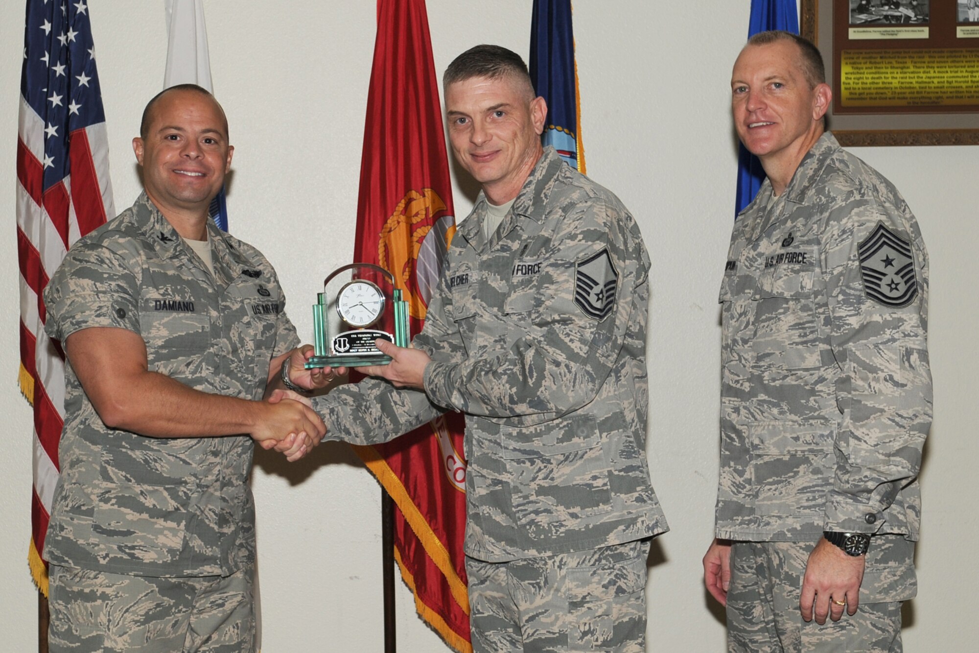 GOODFELLOW AIR FORCE BASE, Texas- Col. Mark Damiano, 17th Training Wing Commander and Chief Master Sgt. Scott Lumpkin, 17th TRW Command Chief, present the 17th Training Wing Senior NCO of the Quarter to Master Sgt. Kevin Belcher, 17th Medical Support Squadron, during the wing quarterly awards ceremony here, Jan. 8. (U.S. Air Force photo by Staff Sgt. Laura R. McFarlane)