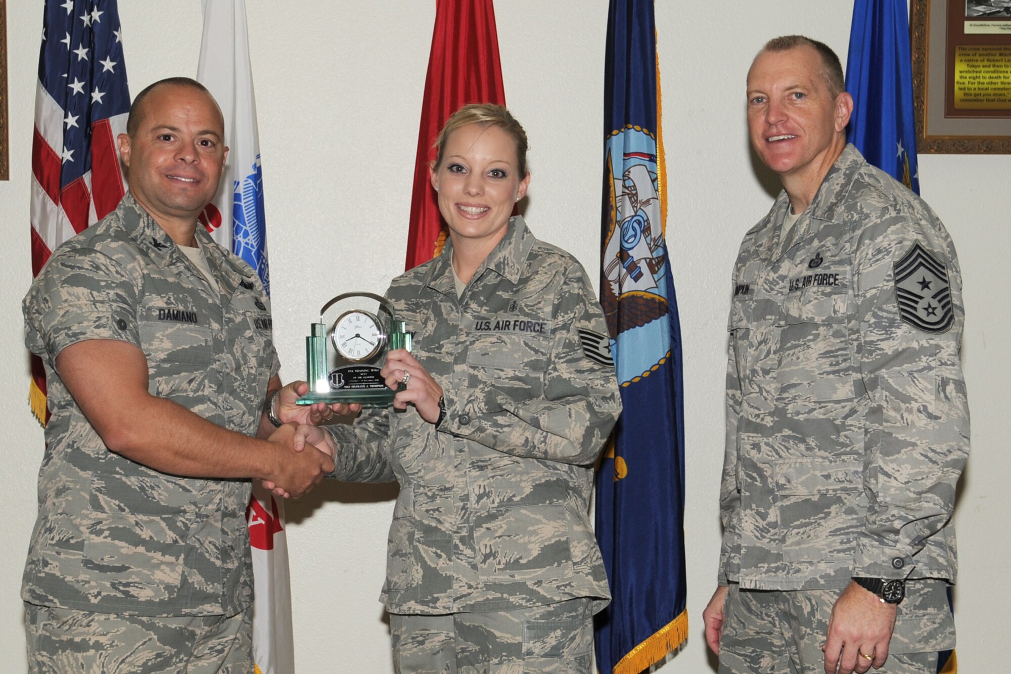 GOODFELLOW AIR FORCE BASE, Texas- Col. Mark Damiano, 17th Training Wing Commander and Chief Master Sgt. Scott Lumpkin, 17th TRW Command Chief, present the 17th Training Wing NCO of the Quarter to Tech. Sgt. Stephanie Thompson, 17th Medical Group, during the wing quarterly awards ceremony here, Jan. 8. (U.S. Air Force photo/ Staff Sgt. Laura R. McFarlane)