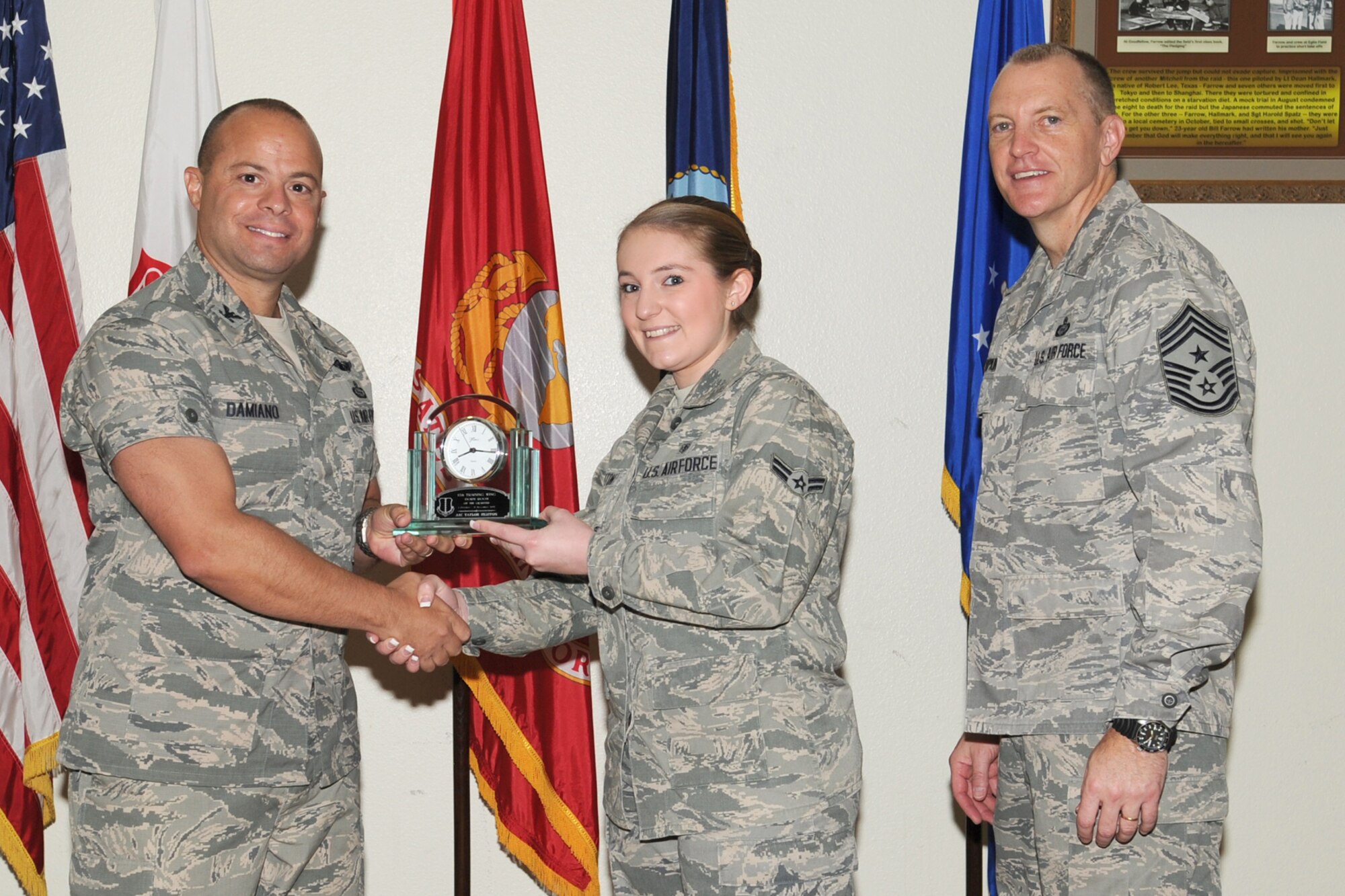 GOODFELLOW AIR FORCE BASE, Texas-- Col. Mark Damiano, 17th Training Wing Commander and Chief Master Sgt. Scott Lumpkin, 17th TRW Command Chief, present the 17th Training Wing Dorm Room of the Quarter to Airman 1st Class Taylor Heuton, 17th Medical Operations Squadron, during the wing quarterly awards ceremony, here, Jan. 8.. (U.S. Air Force photo/Staff Sgt. Laura R. McFarlane)