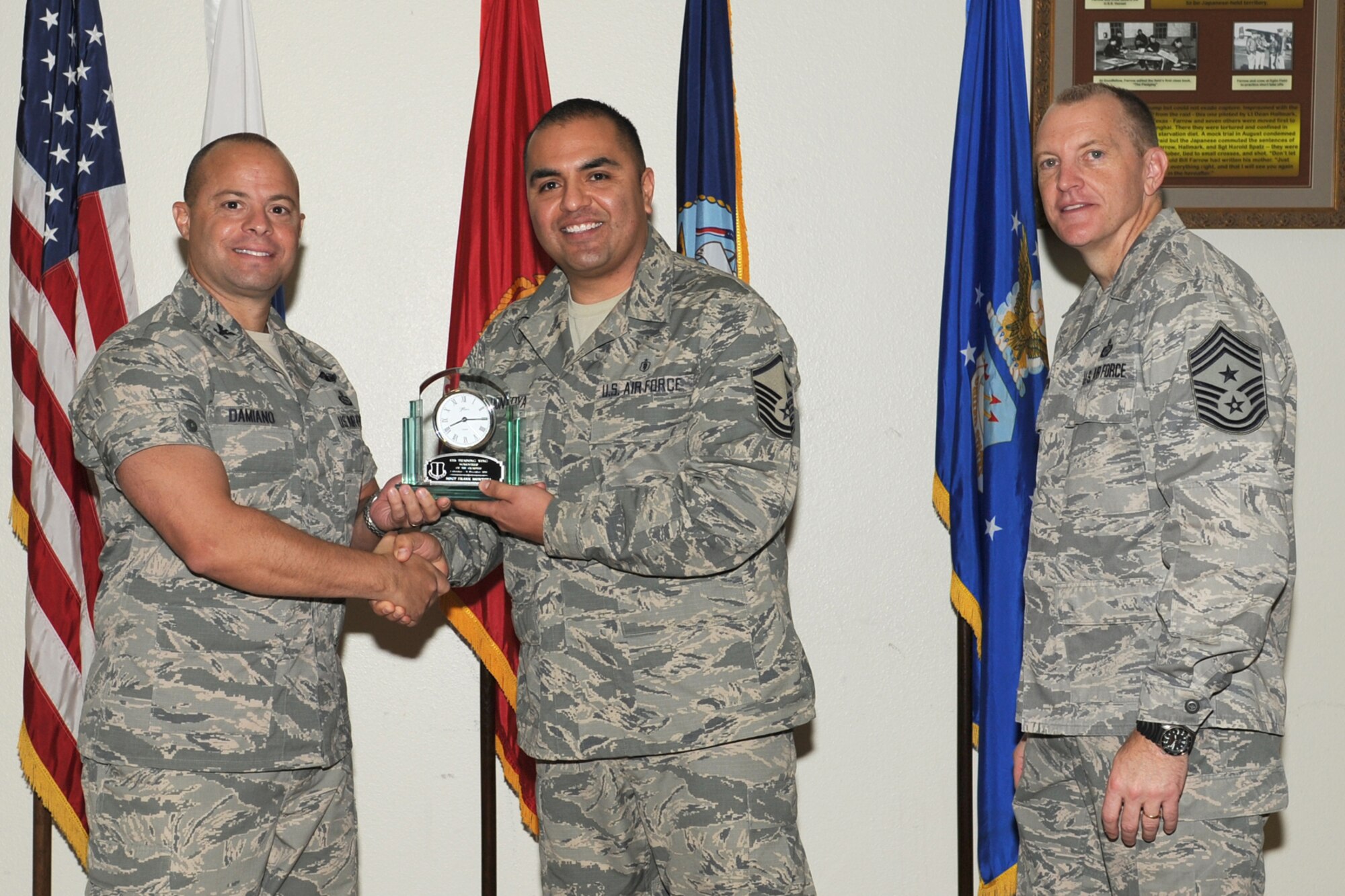 GOODFELLOW AIR FORCE BASE, Texas-- Col. Mark Damiano, 17th Training Wing Commander and Chief Master Sgt. Scott Lumpkin, 17th TRW Command Chief, present the 17th Training Wing Volunteer of the Quarter to Master Sgt. Frank Montoya, 17th Medical Operations Squadron, during the wing quarterly awards ceremony, here, Jan. 8. (U.S. Air Force photo/Staff Sgt. Laura R. McFarlane)
