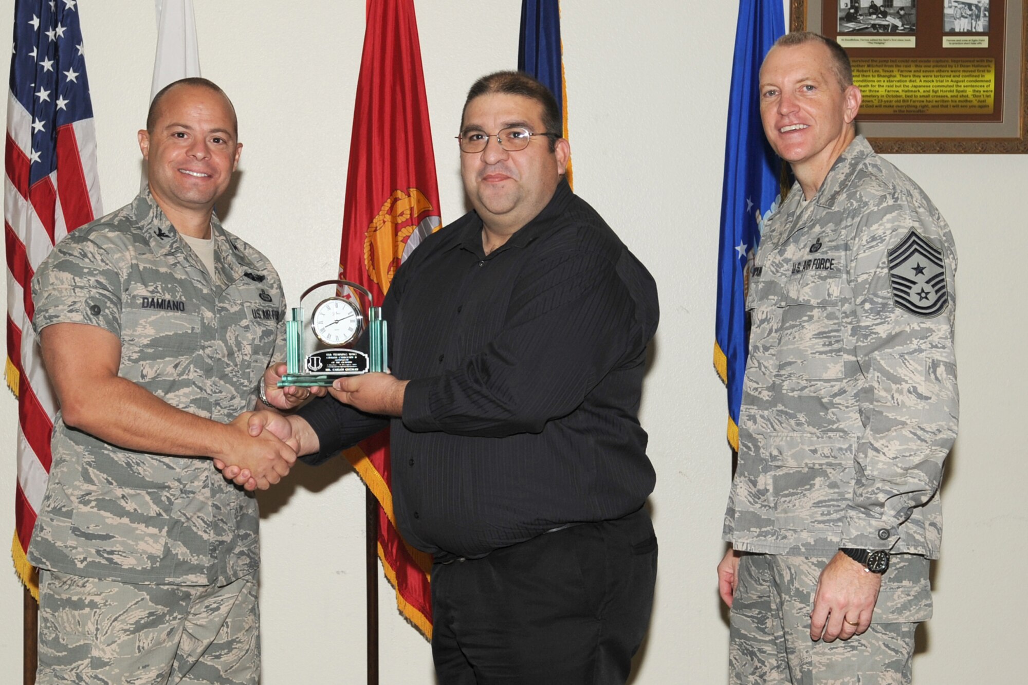 GOODFELLOW AIR FORCE BASE, Texas-- Col. Mark Damiano, 17th Training Wing Commander and Chief Master Sgt. Scott Lumpkin, 17th TRW Command Chief, present the 17th Training Wing Civilian Supervisor of the Quarter Category II to Carlos Guzman, 17th Training Support Squadron, during the wing quarterly awards ceremony, here, Jan. 8. (U.S. Air Force photo/Staff Sgt. Laura R. McFarlane)