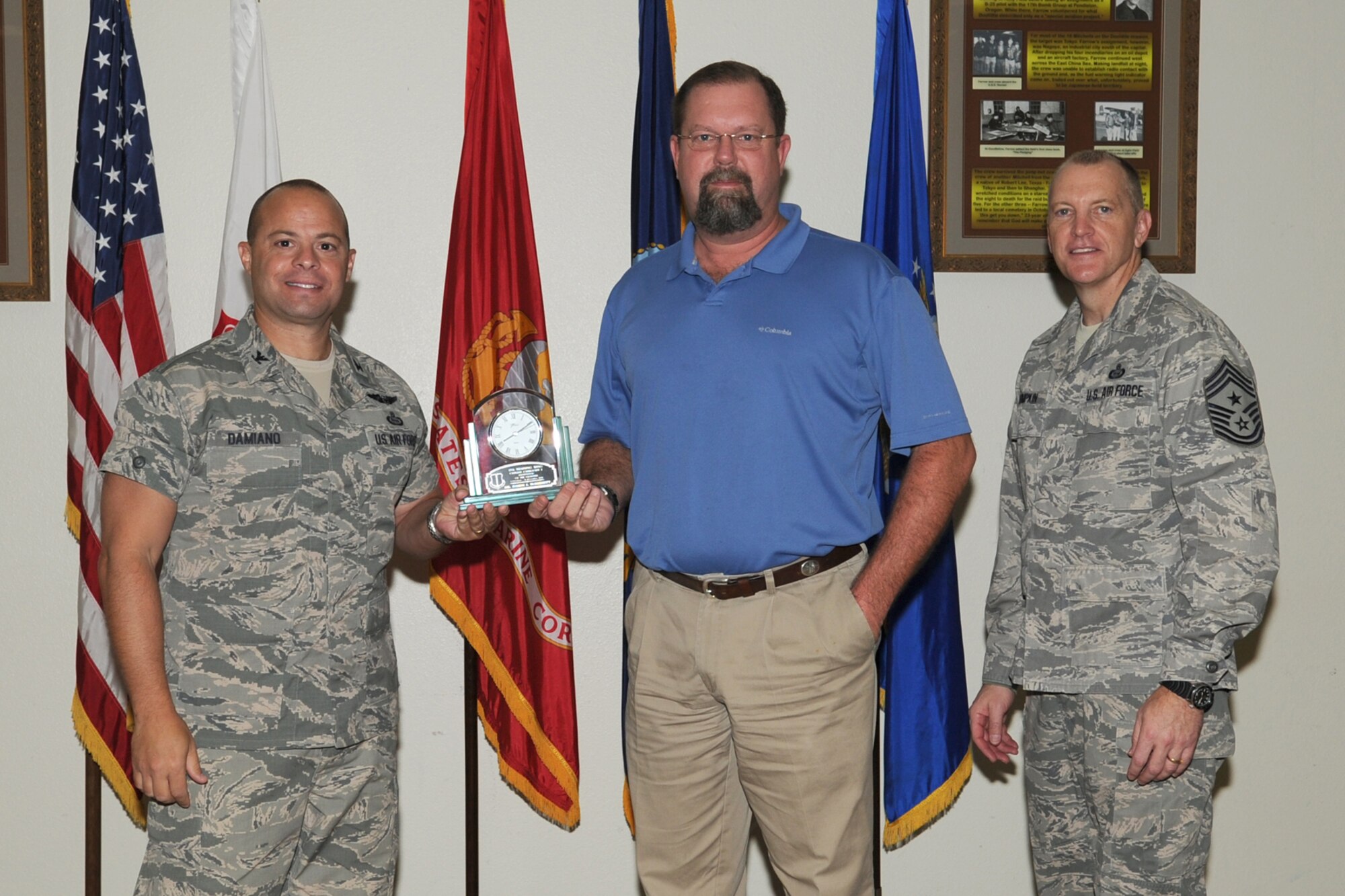 GOODFELLOW AIR FORCE BASE, Texas-- Col. Mark Damiano, 17th Training Wing Commander and Chief Master Sgt. Scott Lumpkin, 17th TRW Command Chief, present the 17th Training Wing Civilian Supervisor of the Quarter Category I to Damon McDurmitt, 17th Mission Support Group, during the wing quarterly awards ceremony, here, Jan. 8. (U.S. Air Force photo/Staff Sgt. Laura R. McFarlane)