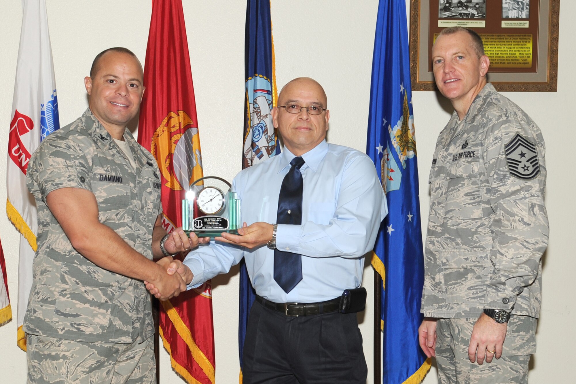 GOODFELLOW AIR FORCE BASE, Texas--  Col. Mark Damiano, 17th Training Wing  Commander and Chief Master Sgt. Scott Lumpkin, 17th TRW Command Chief, present the 17th Training Wing Civilian of the Quarter Category II to Daniel Gutierrez, 17th Medical Group, during the wing quarterly awards ceremony, here, Jan. 8. (U.S. Air Force photo/Staff Sgt. Laura R. McFarlane)