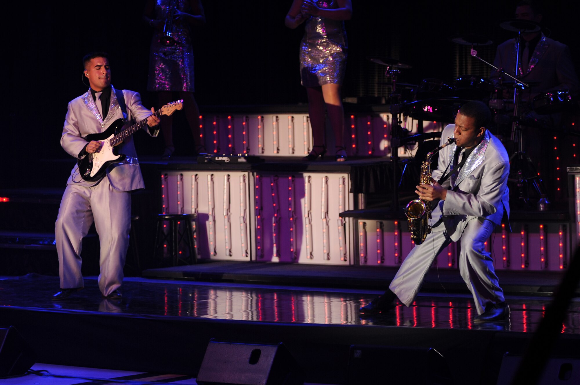 Senior Airman Kenneth Del Valle Ruiz, Tops in Blue guitarist, and Airman 1st Class Wynton Warren, Tops in Blue saxophonist, show off their skills during a performance on Seymour Johnson Air Force Base, N.C., Jan. 7, 2013. Tops in Blue is an expeditionary musical group providing entertainment to service members in 20 different countries, including deployed locations. (U.S. Air Force photo/Airman 1st Class Mariah Tolbert/Released)