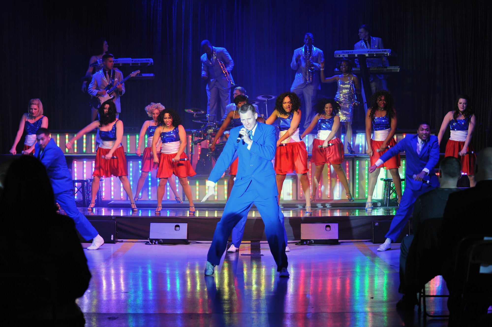 U.S. Air Force 1st Lt. Joseph Mitchell, Tops in Blue vocalist, showcases his dance moves and vocals during a live performance on Seymour Johnson Air Force Base, N.C., Jan. 7, 2013. Mainstream songs were showcased by the band, including hits from Whitney Houston, The Doobie Brothers and Maroon 5. (U.S. Air Force photo/Airman 1st Class John Nieves Camacho/Released)
