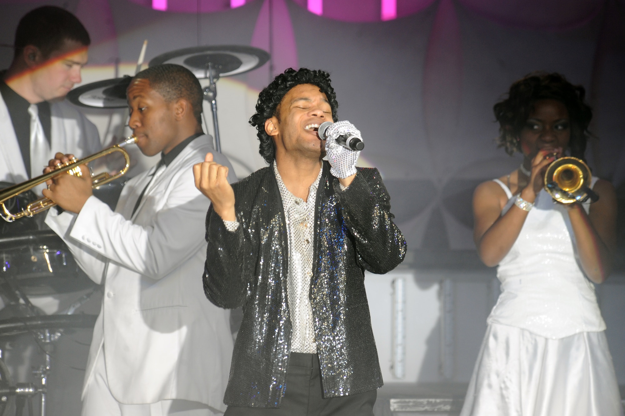 U.S. Air Force Staff Sgt. Tyron Jones, Tops in Blue vocalist, performs a tribute to Michael Jackson during a live concert on Seymour Johnson Air Force Base, N.C., Jan. 7, 2013. Numerous hits from Michael Jackson were played including Smooth Criminal, Thriller and Man in the Mirror. (U.S. Air Force photo/Airman 1st Class John Nieves Camacho/Released)