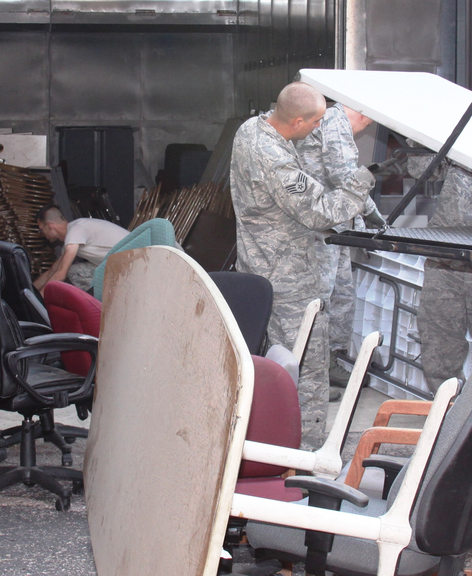 21st Logistics Readiness Squadron members in the midst of a "6S" effort to decide which unused furniture will be repurposed and which will be turned in to DRMO (U.S. Air Force photo/Rick Hughes)
