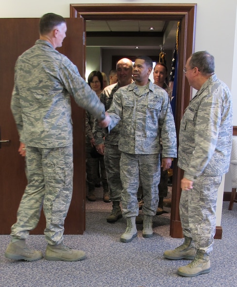 Lt. Gen. Andrew Busch, Air Force Materiel Command vice commander, greets AFMC command chaplain assistant Senior Master Sgt. Kenny Lynch during the Headquarters AFMC command section open house Jan. 7, 2013. Lynch, who recently returned from a deployment to Southwest Asia, and command chaplain Col. Harry Mathis (right), were two of about 700 people who visited the command section to meet with senior leaders and their staffs. (U.S. Air Force photo/Ron Fry)