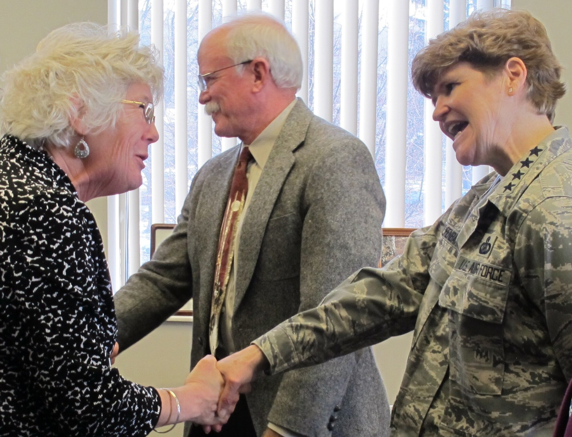 Gen. Janet Wolfenbarger, Air Force Materiel Command commander, and her husband, Col. (ret) Craig Wolfenbarger, greet Martha Smith during the Headquarters AFMC command section open house Jan. 7, 2013. Smith works in the Manpower and Personnel directorate and was one of about 700 people who visited the command section to meet with senior leaders and their staffs. (U.S. Air Force photo/Ron Fry)