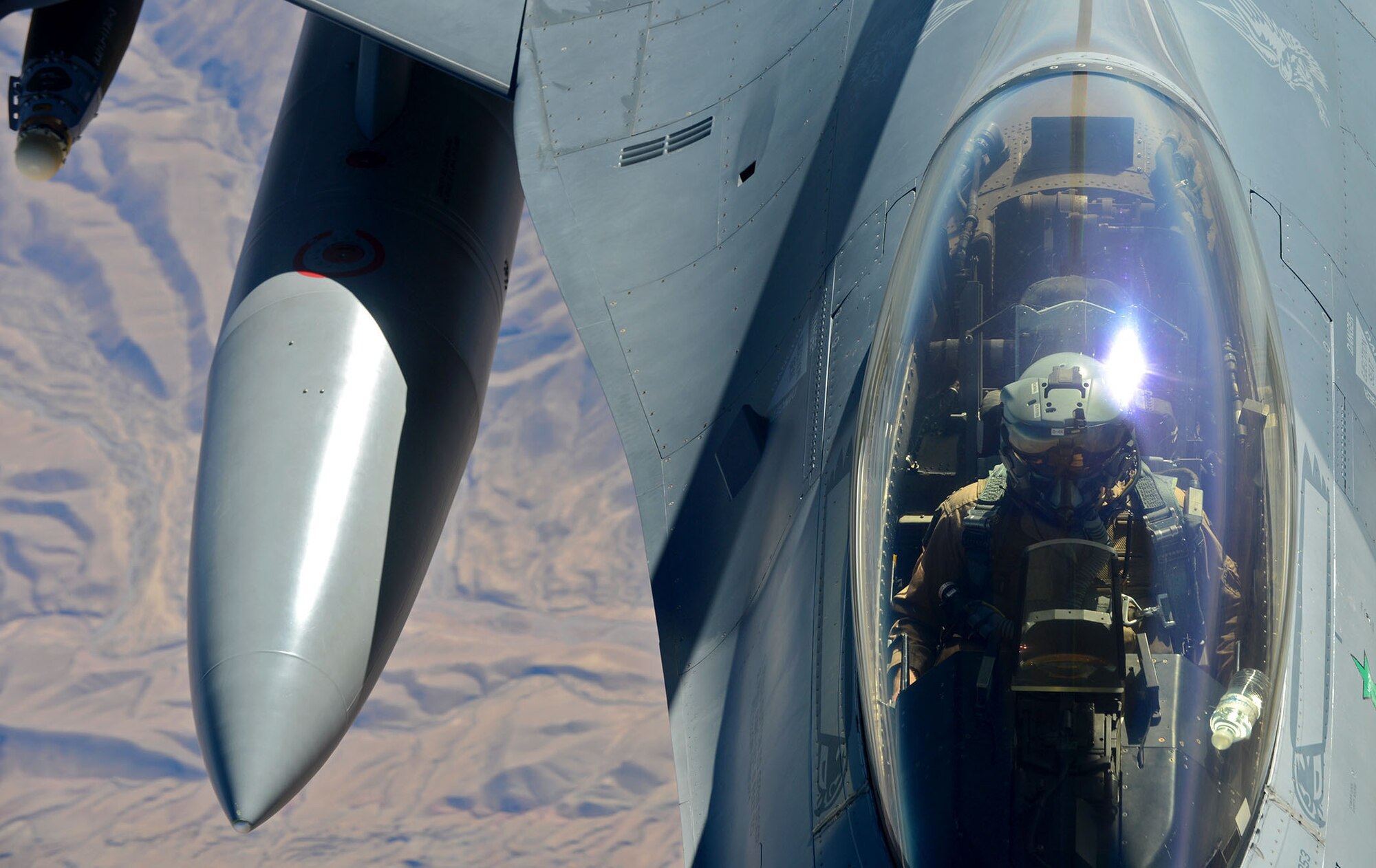 A 77th Fighter Squadron F-16 Fighting Falcon pilot, deployed to Kandahar Airfield, Afghanistan prepares to receive fuel from a 340th Expeditionary Air Refueling Squadron KC-135 Stratotanker over Afghanistan, Dec. 22, 2012. Approximately 300 Airmen and 20 F-16 aircrafts deployed in support of Operation Enduring Freedom in November 2012. The F-16 Fighting Falcon received fuel in order to conduct close air support missions in support of OEF. (U.S. Air Force photo/Staff Sgt. Ashley Reed)