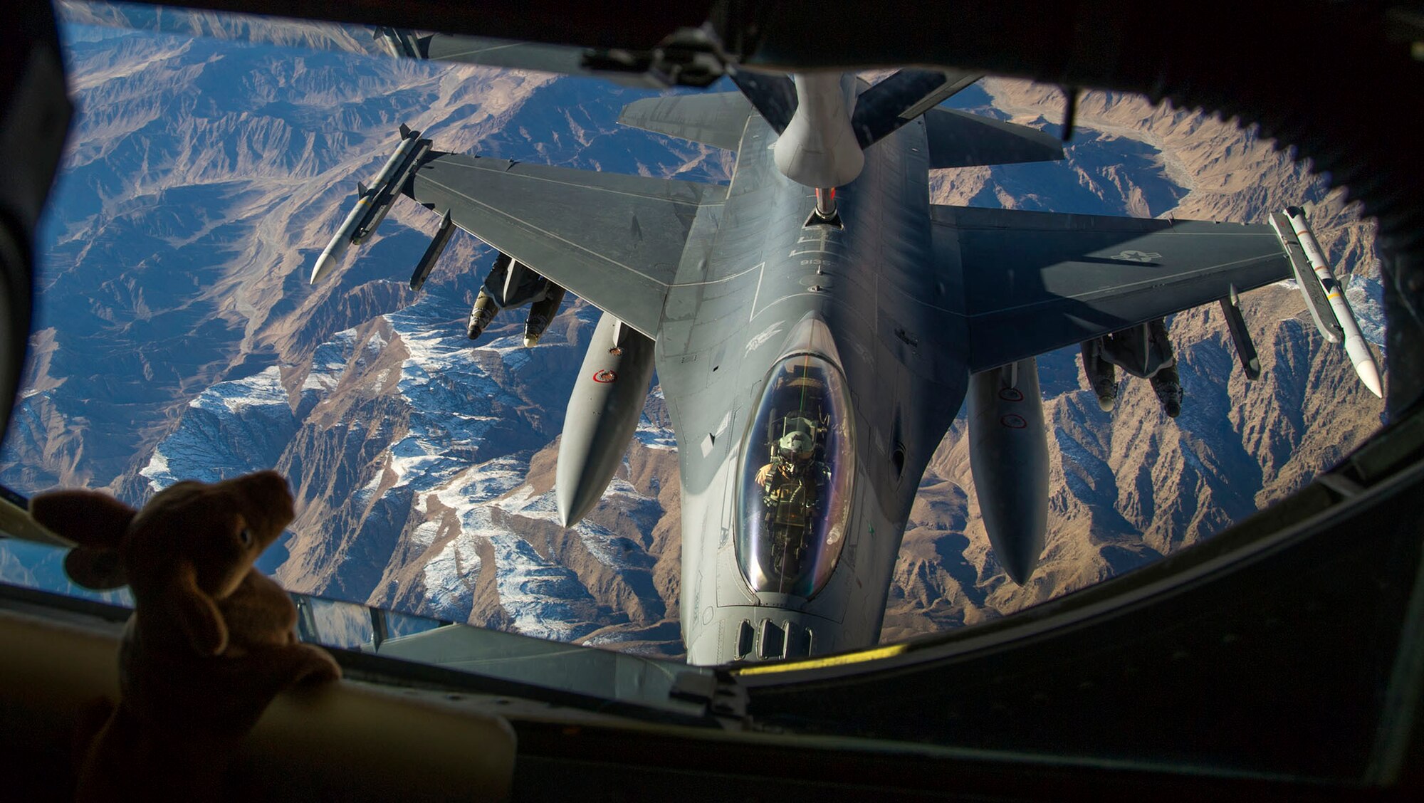 A 77th Fighter Squadron F-16 Fighting Falcon pilot, deployed to Kandahar Airfield, Afghanistan, prepares to receive fuel from a 340th Expeditionary Air Refueling Squadron KC-135 Stratotanker over Afghanistan, Dec. 22, 2012. Approximately 300 Airmen and 20 F-16 aircrafts deployed in support of Operation Enduring Freedom in November 2012. The F-16 Fighting Falcon received fuel in order to conduct close air support missions in support of OEF. (U.S. Air Force photo/Staff Sgt. Ashley Reed)