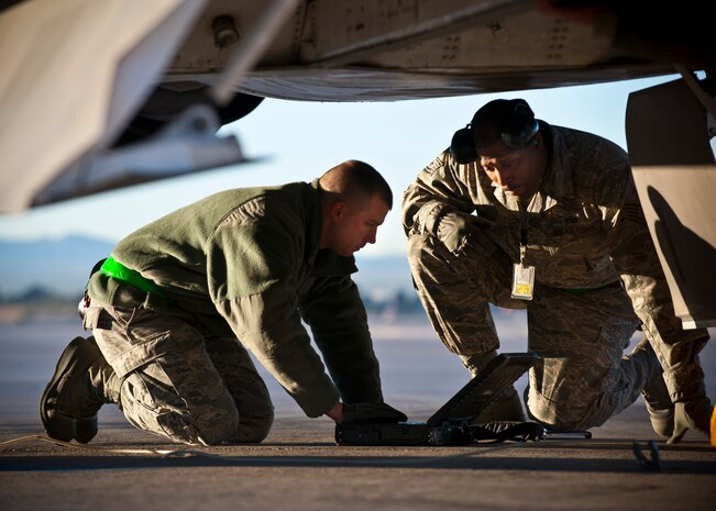 Staff Sgt. Daniel West, 57th Aircraft Maintenance Squadron aircraft armament systems technician, looks through an electronic technical order log during a quarterly load crew competition, Jan. 4, 2013, at Nellis Air Force Base, Nev. Load crew competitions take place four times a year as well as a fifth competition, which is for the title of load crew of the year. (U.S. Air Force Photo by Airman 1st Class Jason Couillard)