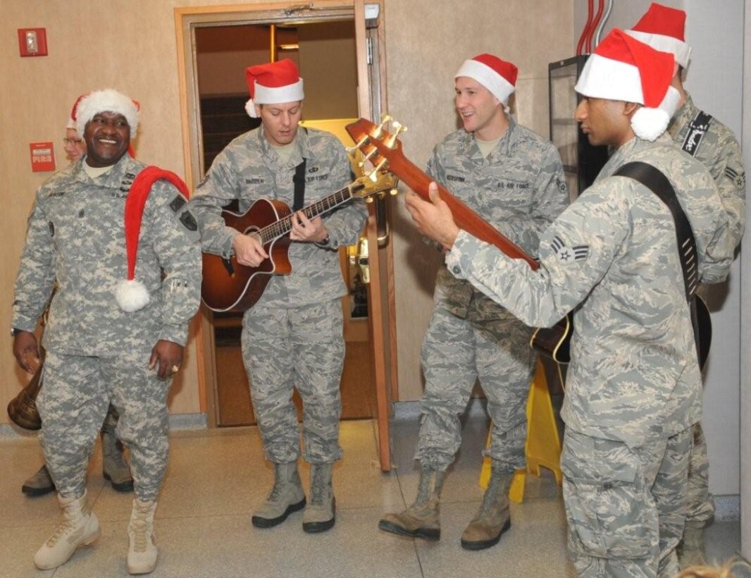 Command Sergeant Major Patrick Alston enjoys Night Wing's Master Sergeant Rick Baisden, Airman First Class Lee Heerspink and Ryan Persaud carol at STRATCOM (Senior Airman Ryan Rager obscured from view)